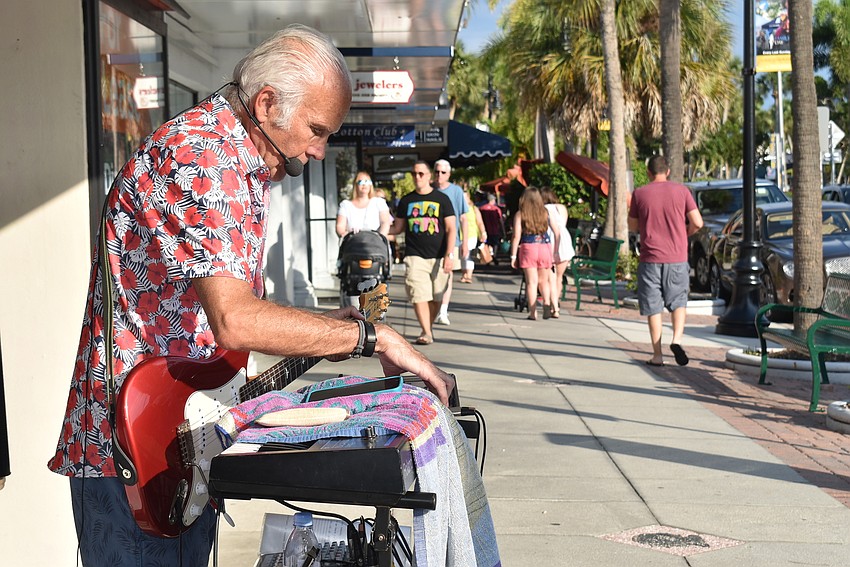 Russell Jennings geared up for his next song as tourists strolled his way.