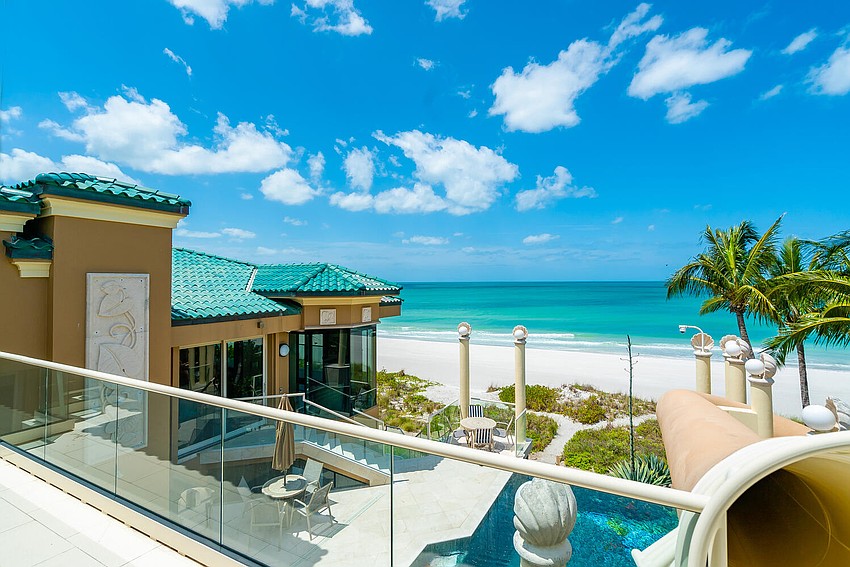 The home's waterslide begins at the rooftop deck above the third level.