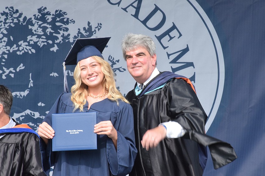 Senior Dabney Bentley commemorates her graduation with David Mahler, the head of school.
