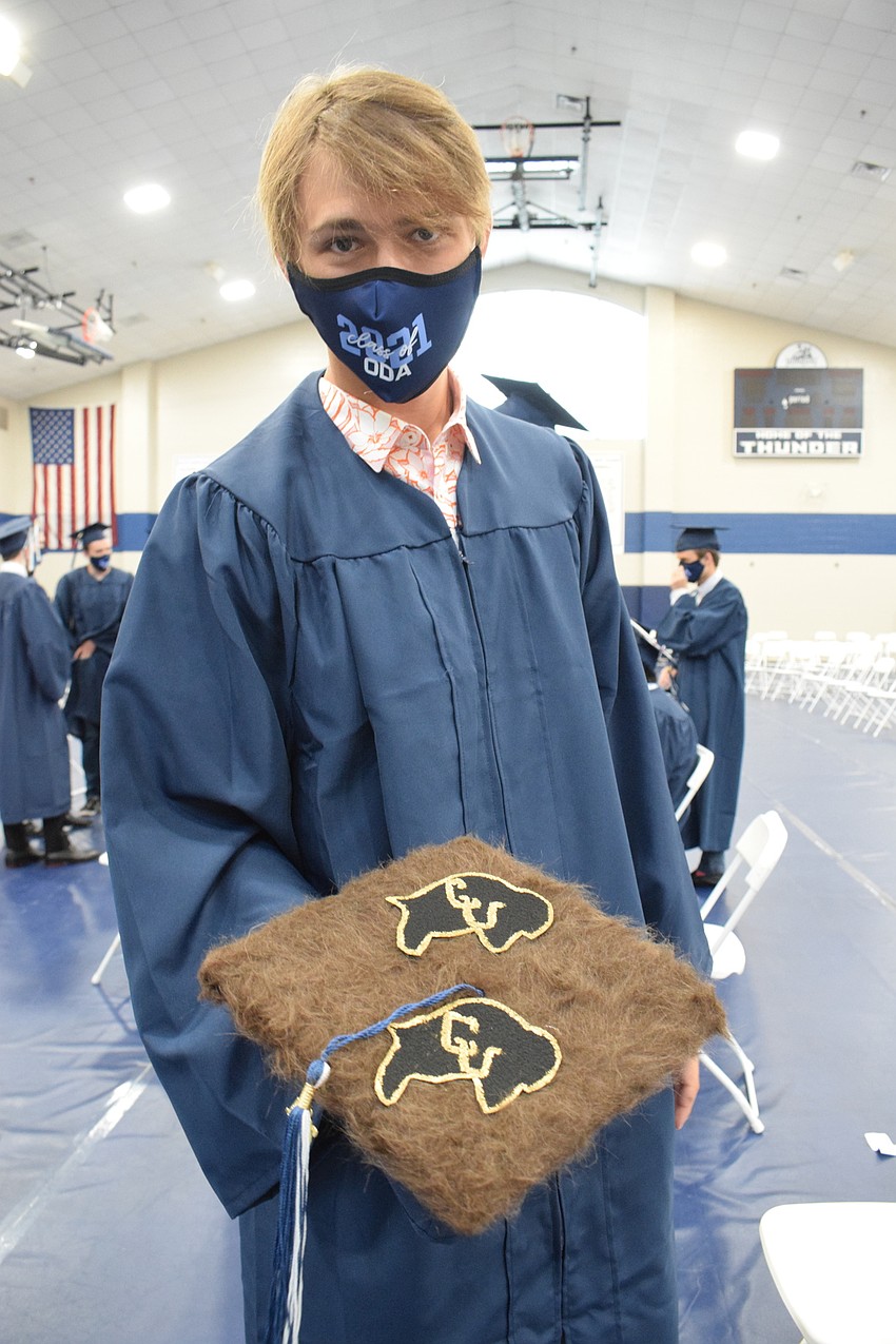 Senior Phineas Scanlan decorates his graduation cap with brown fur because he's headed to the University of Colorado Boulder where the mascot is a buffalo.