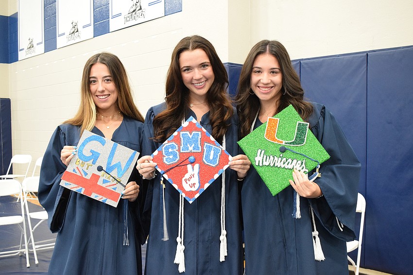 Seniors Lexi Kozel, Monet Ramsey and Amanda Colditz show off their decorated graduation caps that show where they're headed off to college.