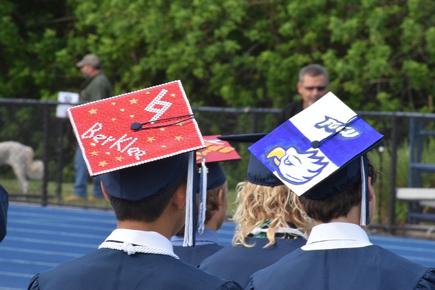 Many graduates decorated their caps to show what university or college they are headed to in the fall.