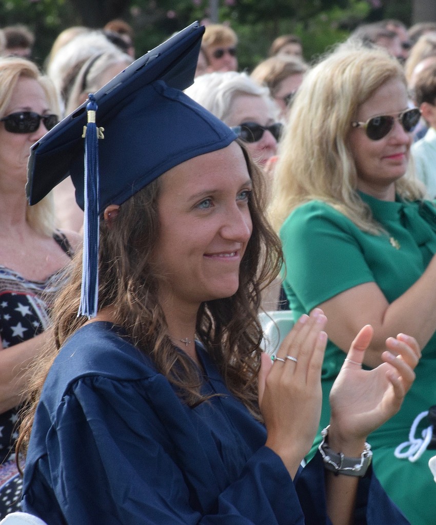 Senior Hailee Toepel claps after senior Jenna Viard gives her speech.