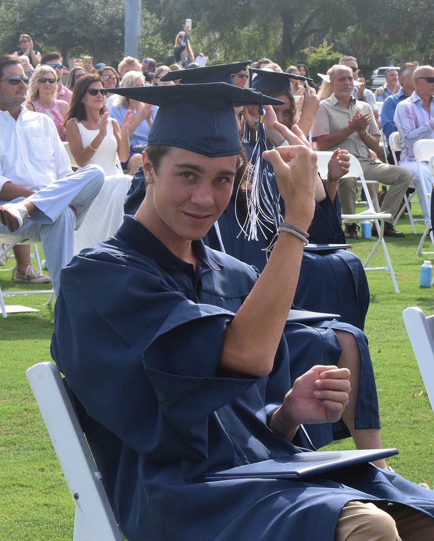 Graduate Cole Kirschner moves his tassel from one side of his cap to the other to signify his graduation from high school.