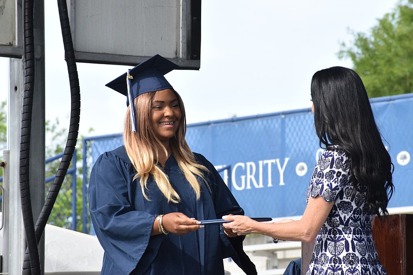 Senior Grace McCollum accepts her diploma from Ashley Kozel, the chair of the Out-of-Door Academy's Board of Trustees.