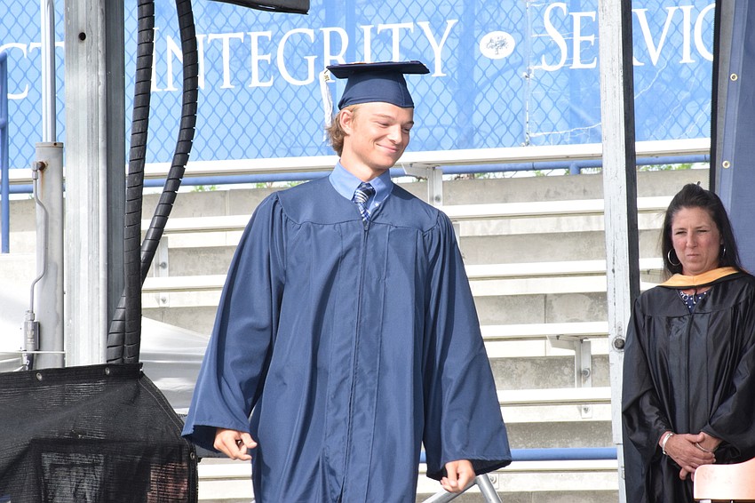 Senior Michael Carlton walks across the stage to get his diploma.