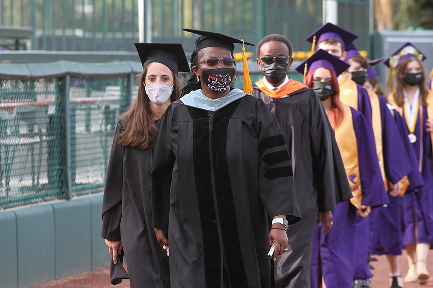 More than 200 students walk to their seats at Ed Smith Stadium.