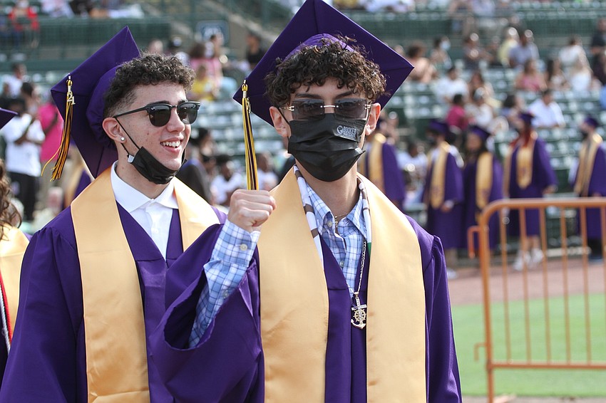 Ricardo Muñoz gives a thumbs up walking to his seat.