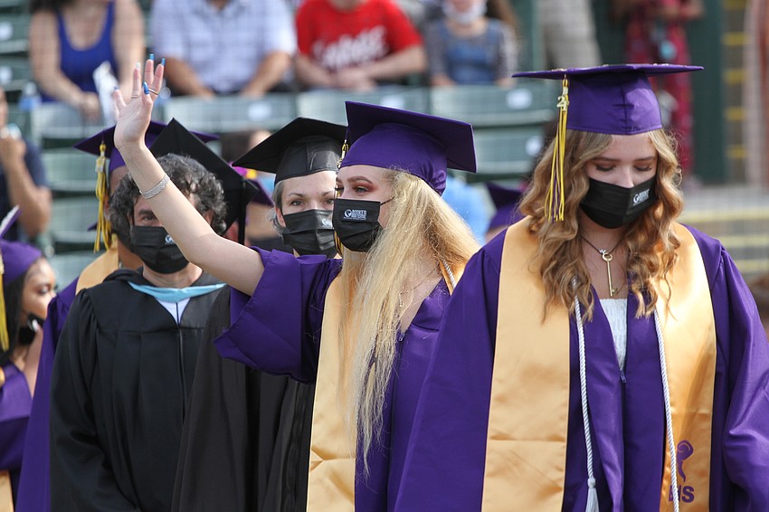 Rylee Martin waves to people in the stands.