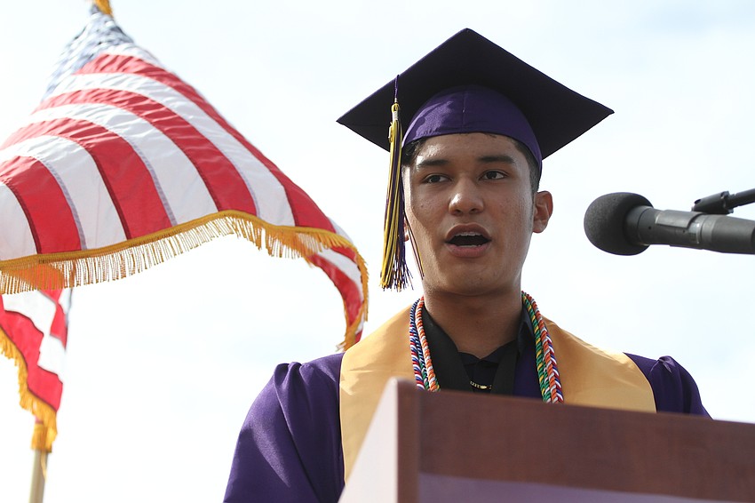 Erik Reynoso-Placencia speaks to the audience as commencement speaker.