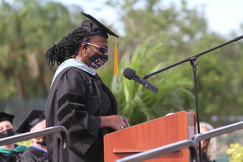 Principal Rachel Shelley breaks out the shades to speak to her school's graduates.