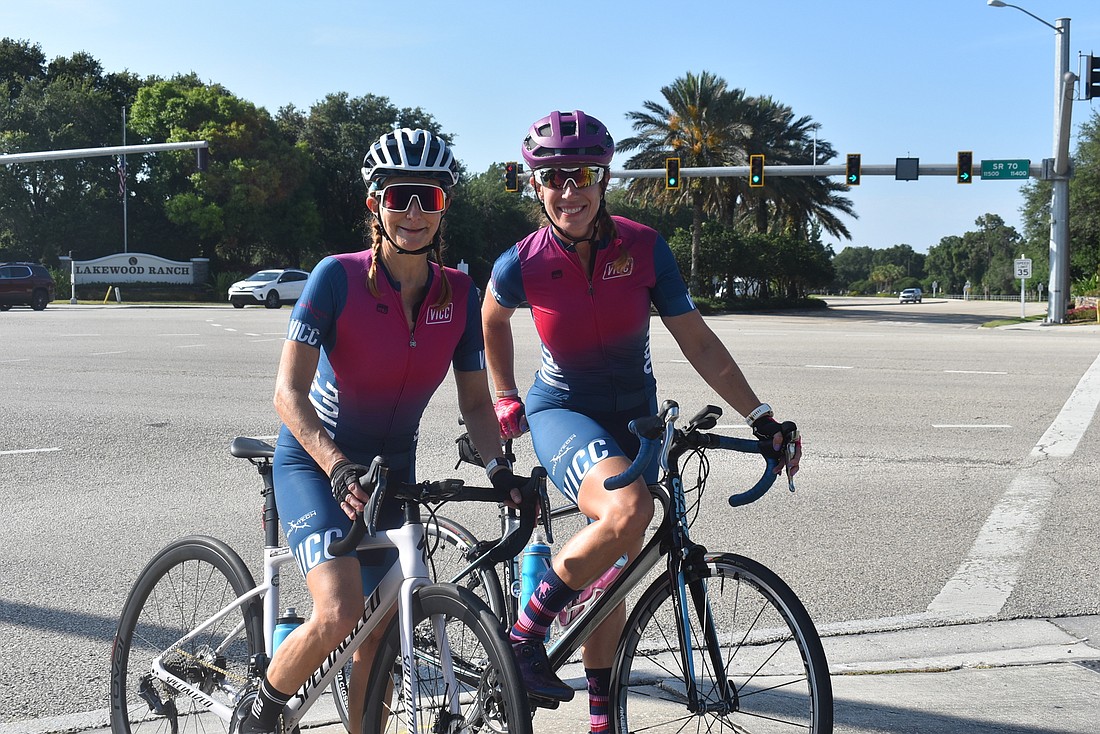 Village Idiots Cycling Club members Andrea Sacchetti and Dawn Zielinski stand at the intersection of State Road 70 and Lakewood Ranch Boulevard, where a bike lane will be reinstated on the southbound part of the latter street.