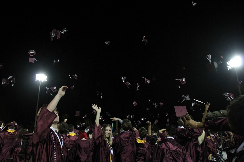 The class of 2021 tosses their caps high into the air.