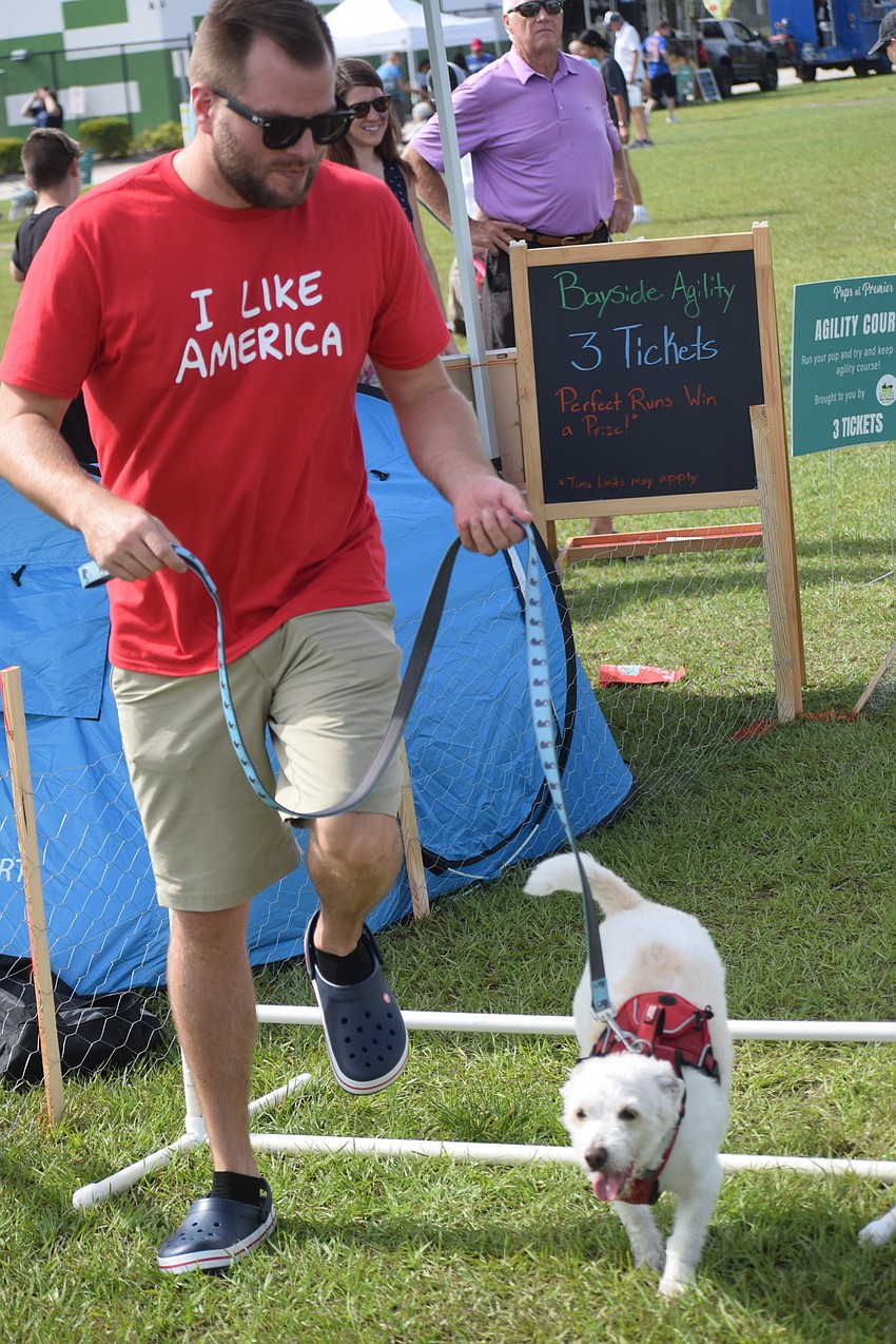 It's hard to tell who is having more fun on the obstacle course, Sun City's Brian Boone or his poodle-terrier Tobey.