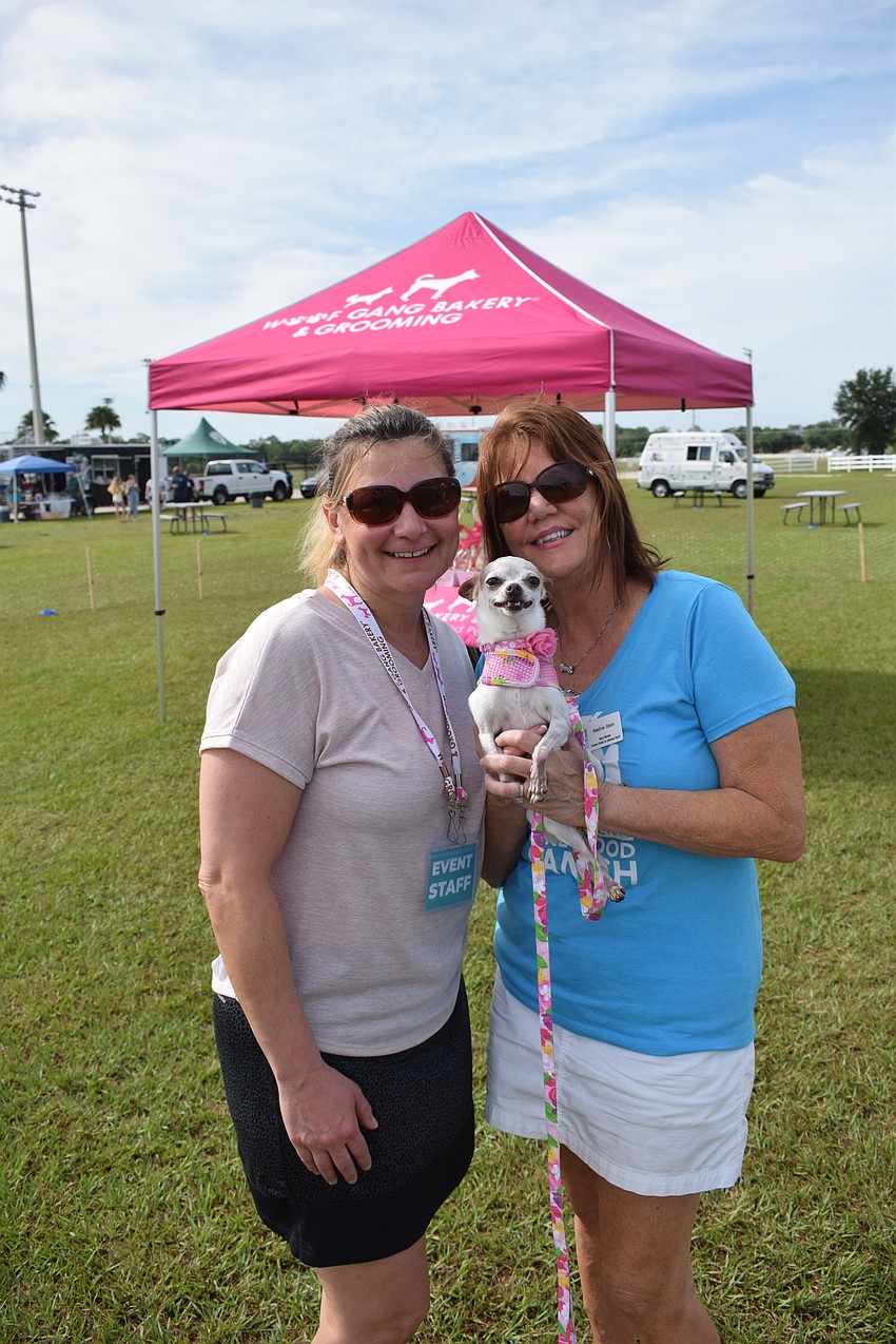 Dottie DeCarlo, the owner of Woof Gang Bakery and Dog Grooming, and Nadine Stein of the Humane Society of Lakewood Ranch, hold Stein's rescue dog Havana.