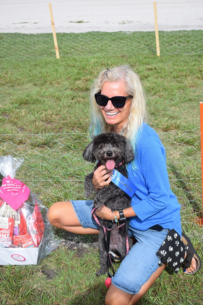 Lakewood Ranch's Lisa Breitberg holds 4-year-old Tica after the Havanese won a blue ribbon in the Running of the Pups.