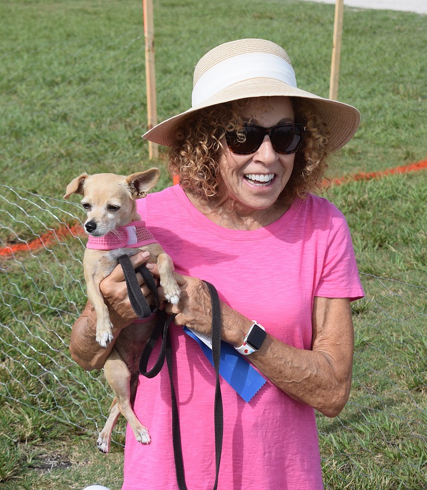 Katy, a Chihuahua mix, won a heat of the Running of the pups.Katy is held by owner Anne Gold of University Park.