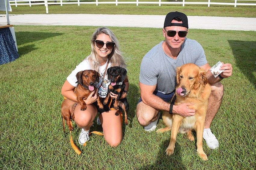 Chrissie Lee, holding Hudson and Dexter, and Charles Lee, holding Harley, say their dogs have different personalities but they all love each other.