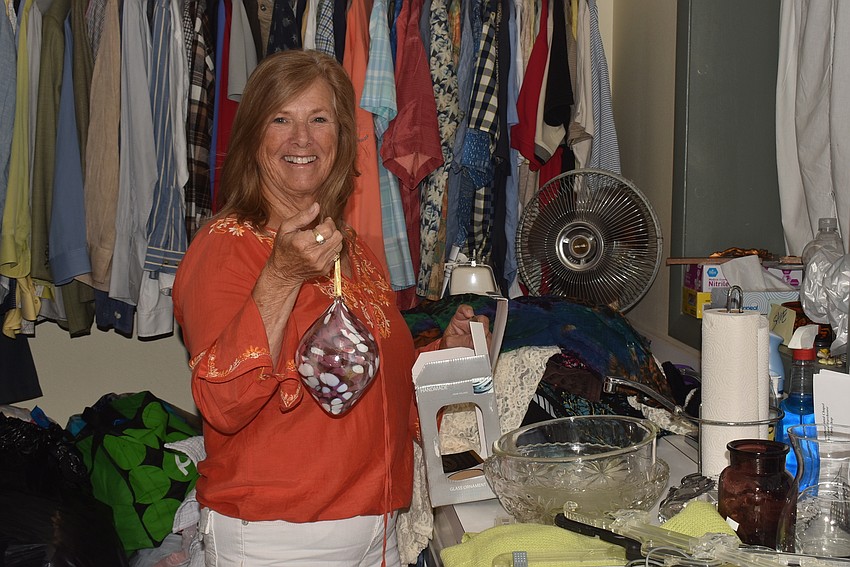 Virginia Luke holds up an ornament that was donated.