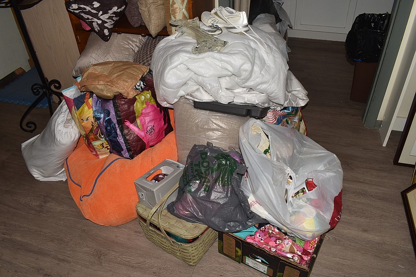 Piles of donations crowd the Warehouse workers.