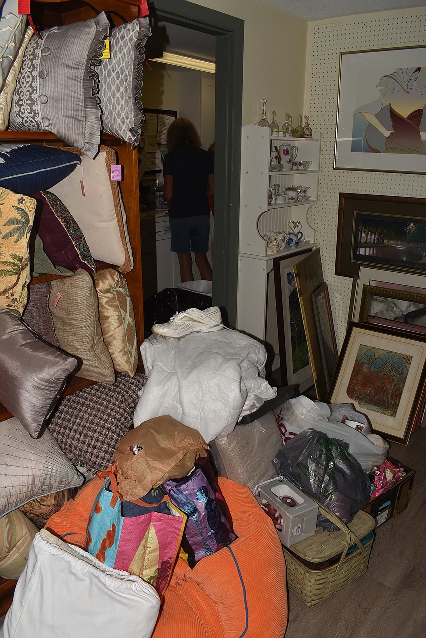 Piles of donations crowd the Warehouse workers.