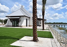 An area called "Second Park" will have artificial turf, views of the lake and eventually cornhole. The stainless steel wire fence allows for views of the lake.