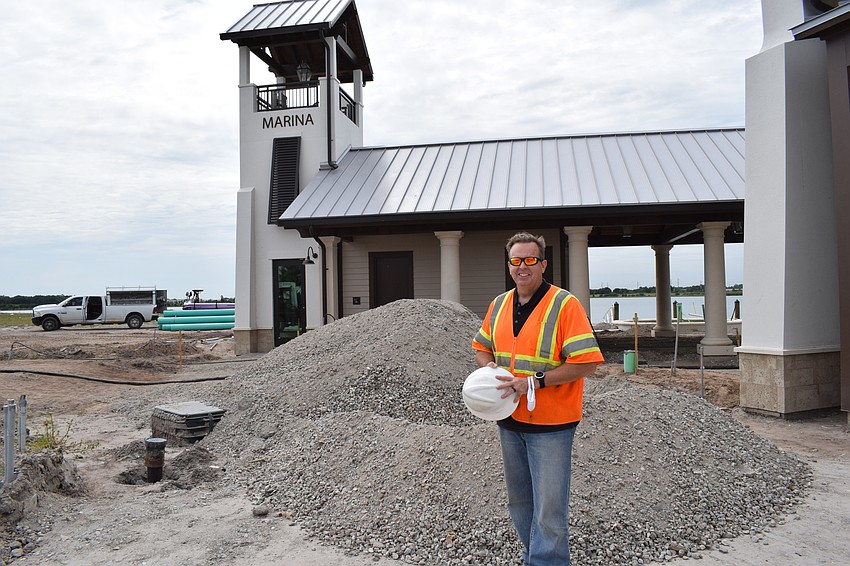 Jason Rinard, standing in front of the marina, expects landscaping to be finished by early July.