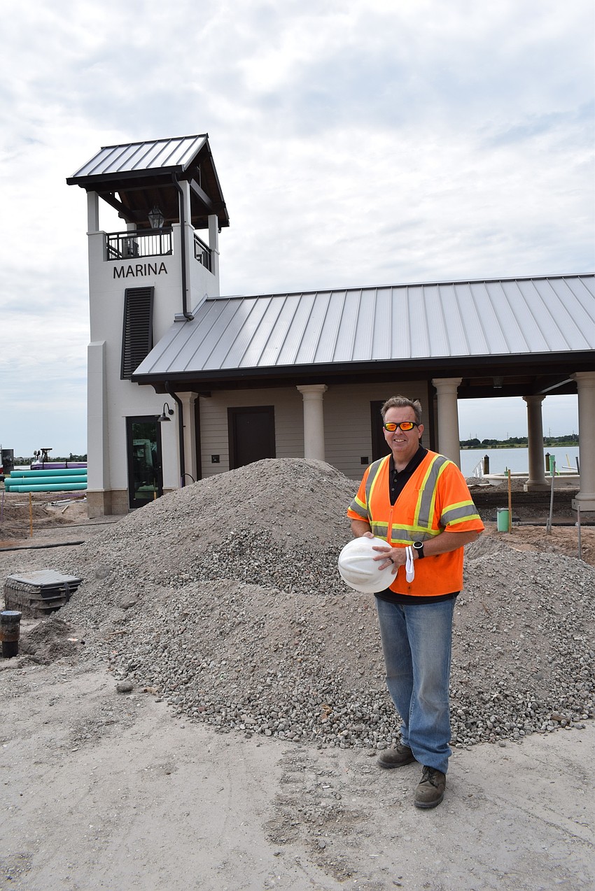 Jason Rinard, standing in front of the marina, expects landscaping to be finished by early July.