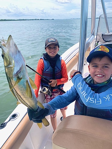 Connor and Owen Fitzpatrick show off the fish they caught. It&#39;s a Fitzpatrick family tradition to try to catch a fish to make for dinner on the Fourth of July. Courtesy photo.