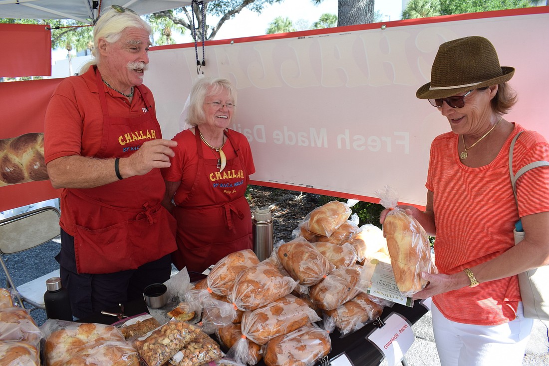 Ron and Betty Jo Baca show their Baca Bread products to Lucy Dowd of Venice.