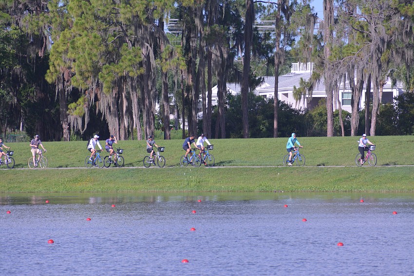 Bikers at Nathan Benderson Park would race alongside the rowers at the 2021 USRowing Youth National Regatta, following the action.