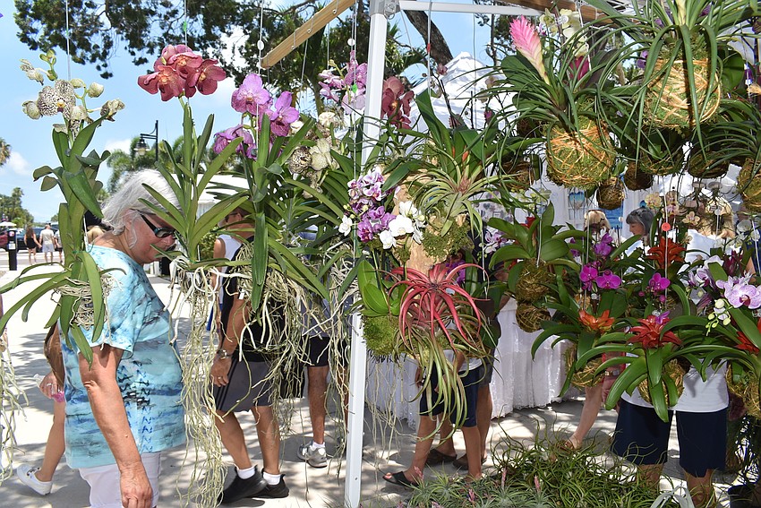 Shoppers stopped at the plentiful flower stand.
