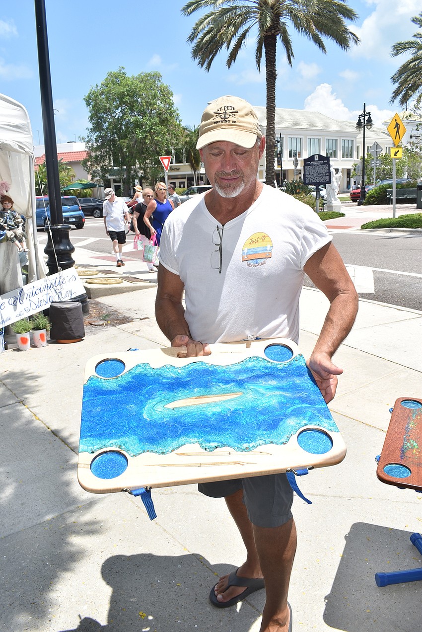 Dave Wennick shows his solar-powered beach table.