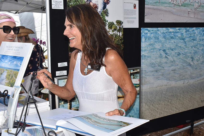 Mary Lou Johnson signs a book.
