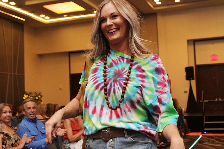 Models walk up and down the runway.