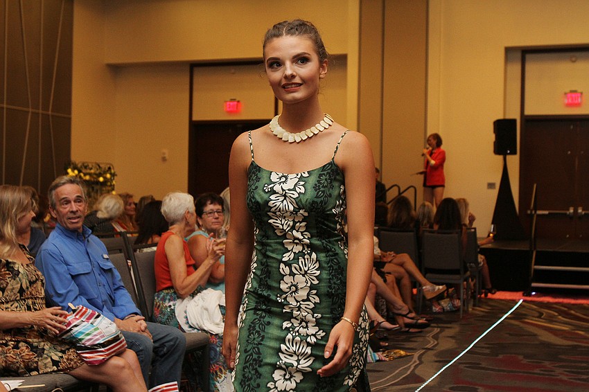 Models walk up and down the runway.