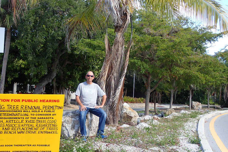 Siesta Isles Association President Tony Romanus sits, in November, in one of the medians in which the beautification project is taking place. The stop-work order was subsequently lifted and the project is now underway again.