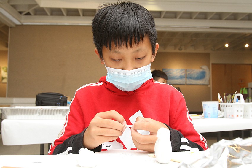 Daniel Lu, 13, works on his owl.