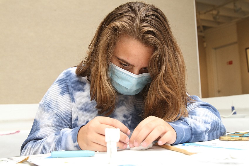 Francesa Bisordi, 12, slowly crafts her lion human figure.