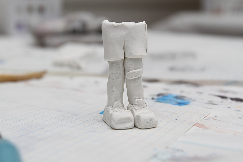 Francesa Bisordi, 12, slowly crafts her lion human figure.