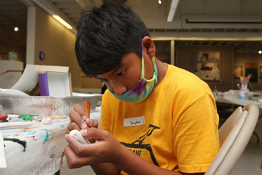 Jayden Navor, 12, sets to work on his bird sculpture.