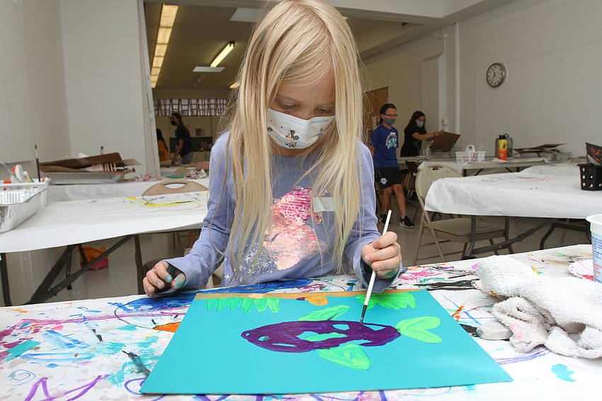 Diana Stutzman, 8, paints a fish,