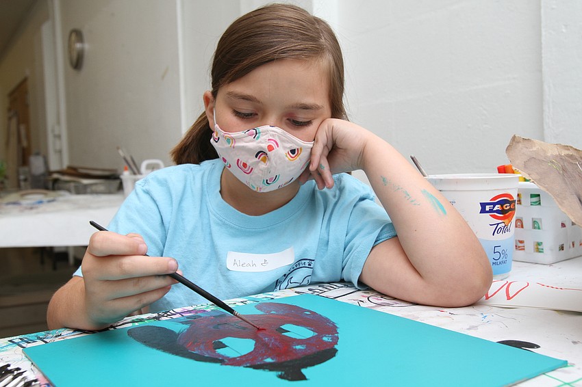 Aleah Echols, 8, puts the finishing touches on her dog painting.