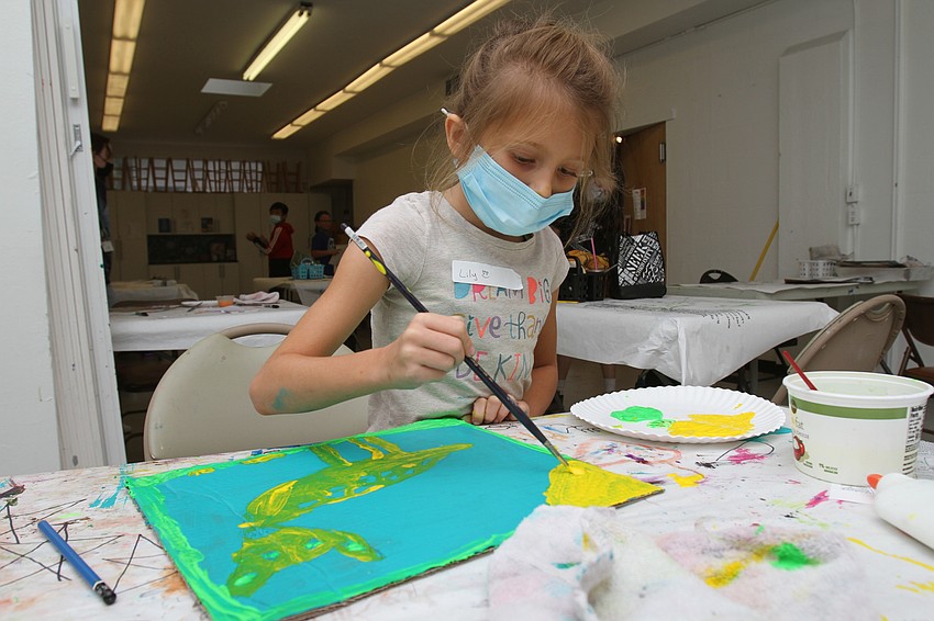Lily Bunker, 7, adds color to her deer.