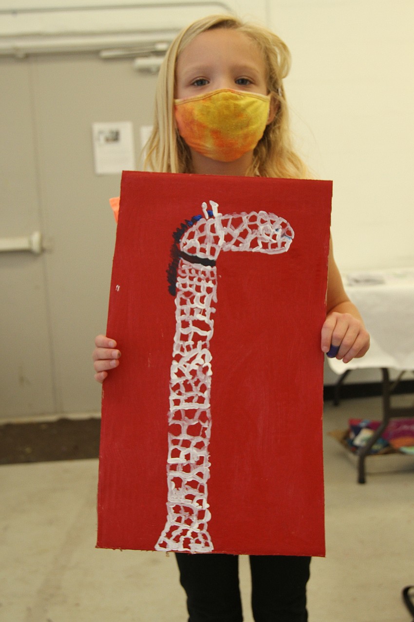 Dylan Gates, 6, is happy to finish her giraffe.