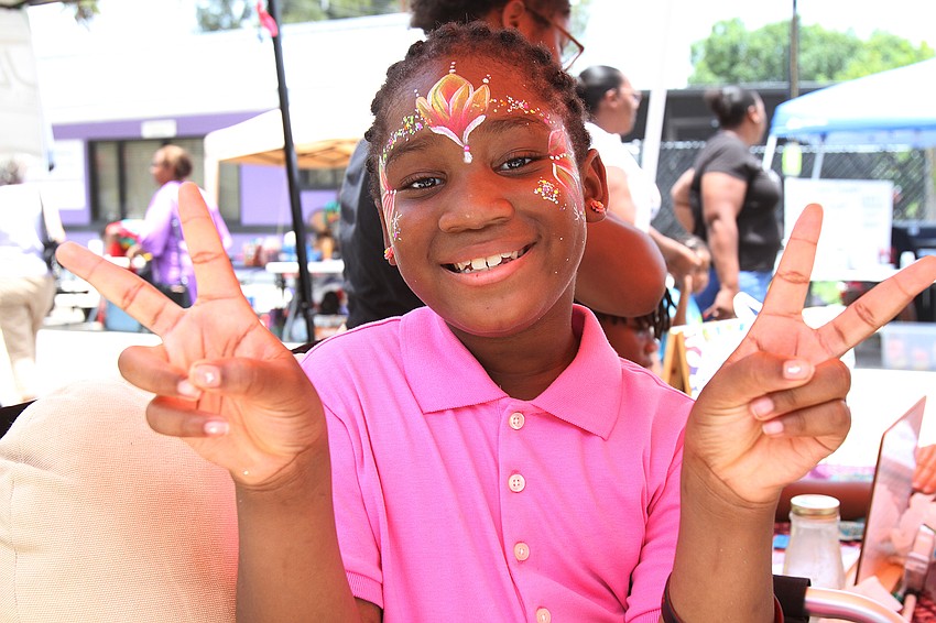 Arina McClemons shows off her henna designs.