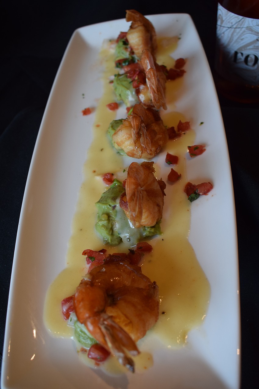 Drunken shrimp ($14.99), wrapped in bacon with tequila lime butter sauce, and guacamole is one of the appetizers.