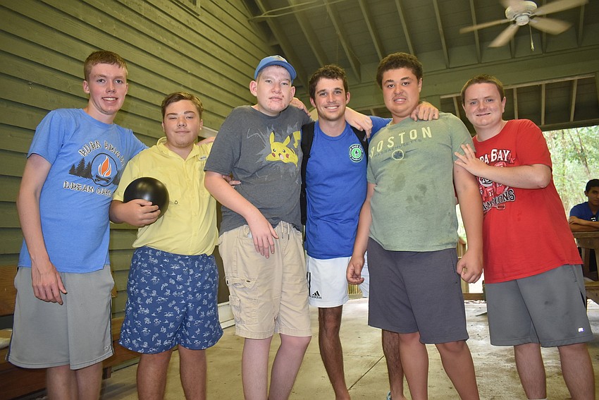 Sydney Lambert, 16, Steven Bass, 17, Jacob Fiske, 16, camp counselor Luke Pellegrino, Vivaldi Polanco, 17, and Robert Mahurin, 16, take a break from bowling, which they played during the math and science section of camp.