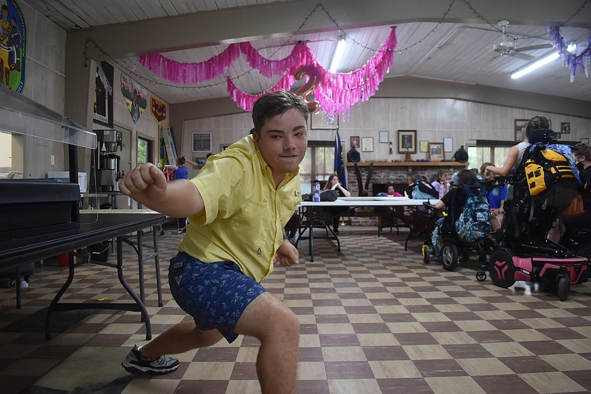 Sarasota's Steven Bass, 17, dances through the cafeteria to the tune of a song from the musical 