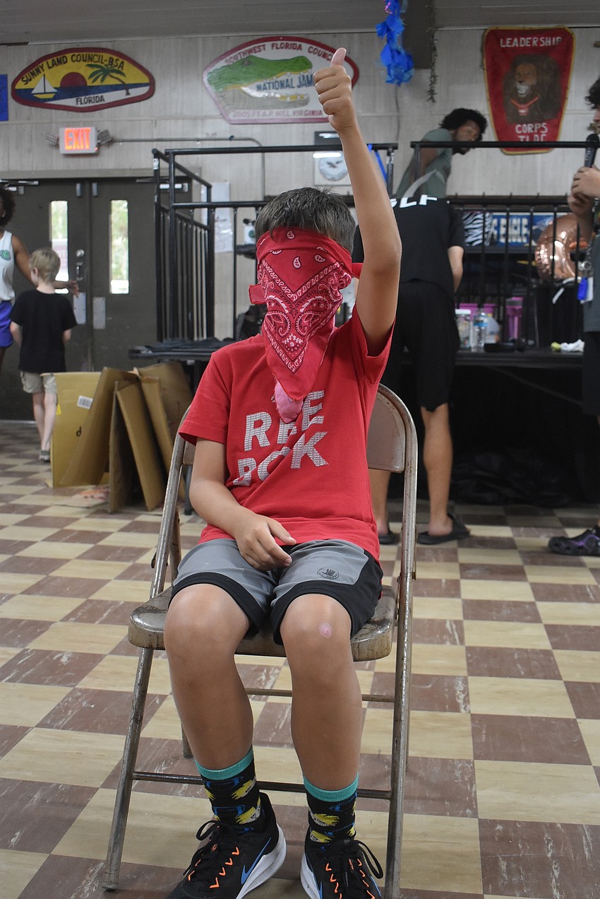 Benjamin Ruthven, 9, signals that he is ready to begin playing Four Corners. After contestants chose to stand in one of the room's four corners, Ruthven called a number one to four to eliminate those standing in that corner.
